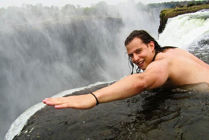 Small-Group Devil's Pool and Livingstone Island Tour - Sitting at the lip of Victoria Falls